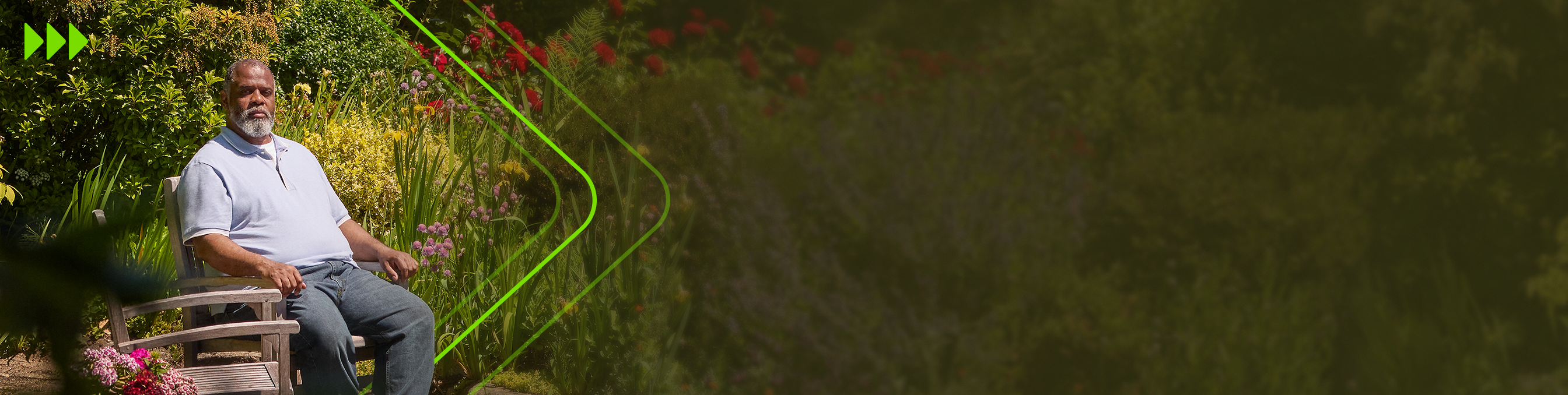 Man in blue jeans and blue shirt sitting in a chair in his garden 