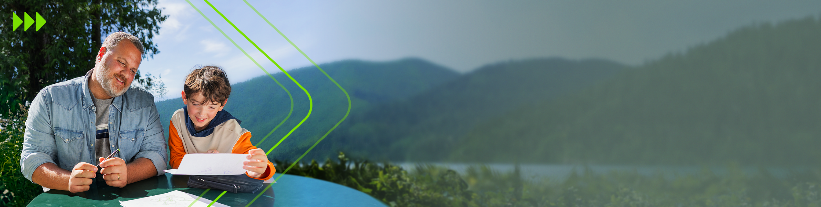 Man with his son at a table looking at a map